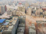 Smokes rising as buildings crumble