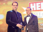 Vineet Jain (R) presents the young business leader of the year award to Sanjiv Bajaj