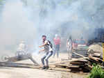 Masked protestors pelt stones at policemen