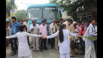 Girls block road, seek paper review