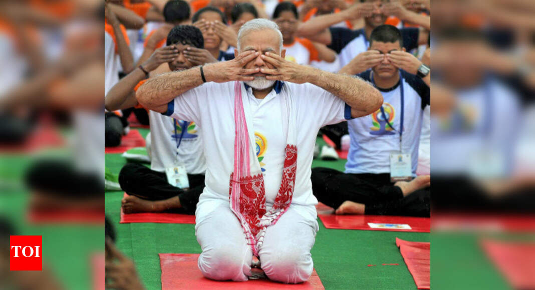 Narendra Modi: PM Modi performs asanas despite rain, says yoga connects ...