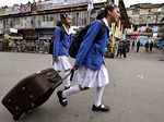 School girls walk during a general strike called by GJM