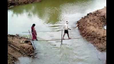 Here, villagers have to walk on iron rod to cross river