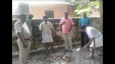 Police with broom in hands,instead of lathi