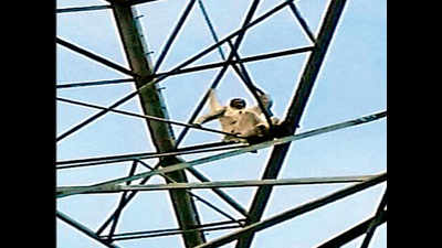 Man climbs power tower to seek filing of case into son’s murder