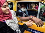 ​ A Muslim woman tying a rakhi