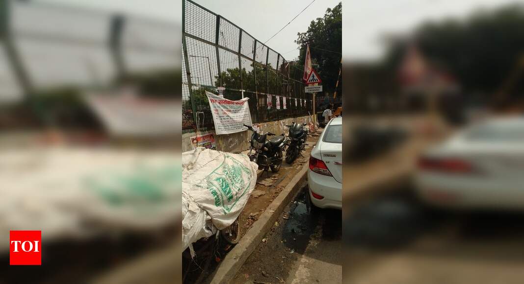 Footpath encroached - Times of India