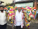 A man poses with his two decorated bullocks