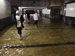 Commuters make their way through a flooded subway