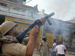 ​ A policeman fires teargas shells to disperse the crowd
