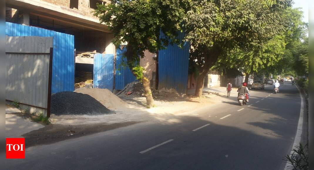 Footpath encroached for construction of building - Times of India