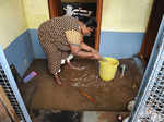 A woman drains out rainwater