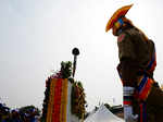 A police personnel pays homage to martyrs