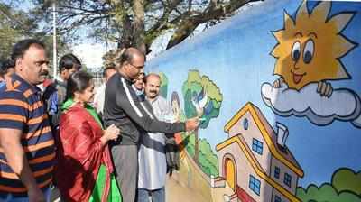 Students create art and paint on Wesley Cathedral wall