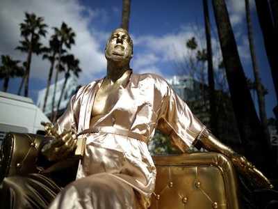 Gold Harvey Weinstein statue in bathrobe at Oscars