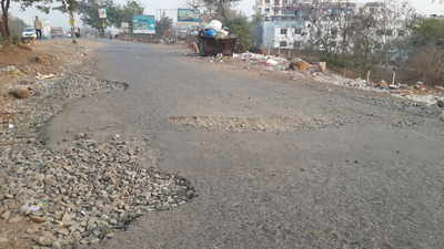 poor quality pothole ridden service road