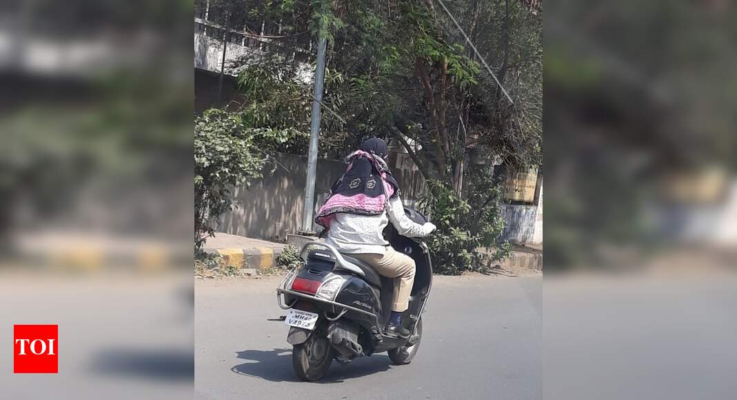 Riding without helmet. Times of India