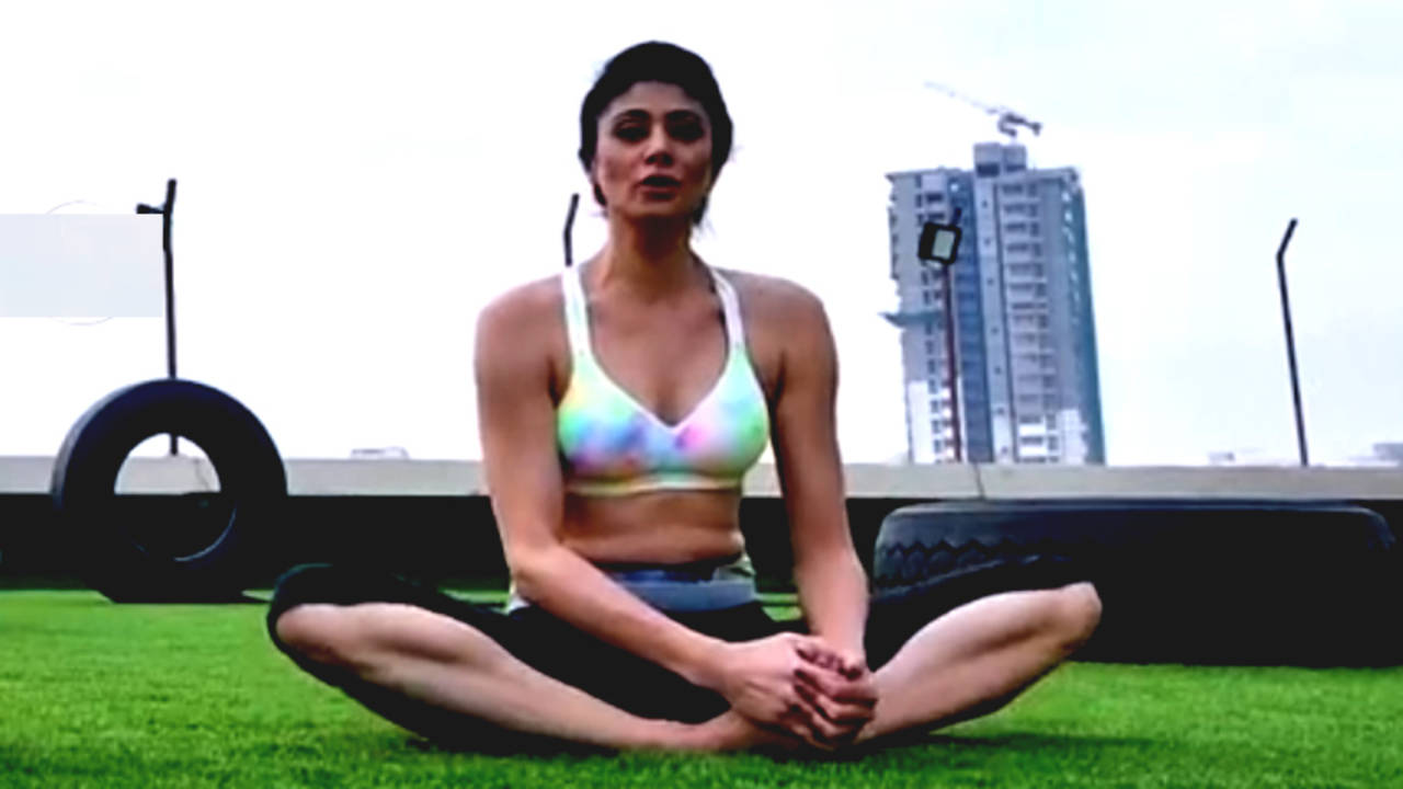 practicing yoga in the butterfly pose (Baddha Konasana)