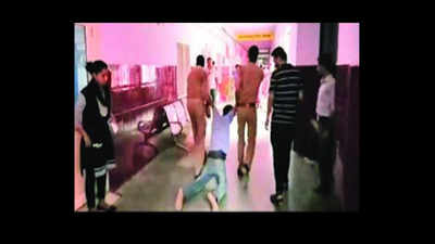 Cops drag unconscious thief down hospital corridor in video, suspended