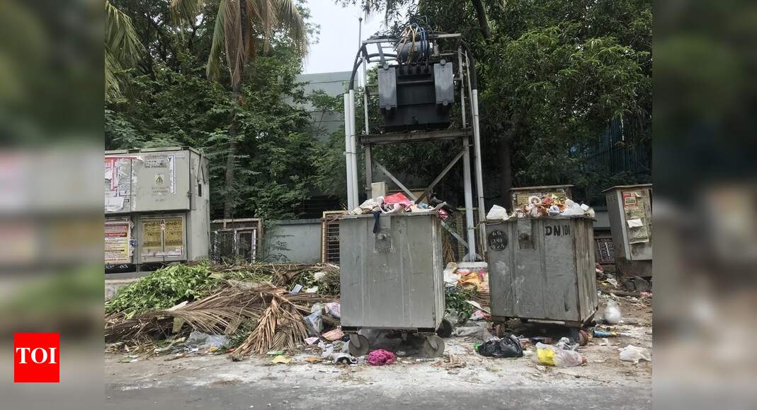 overflowing trash bin - Times of India