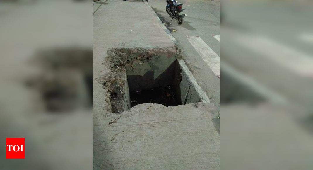 Broken footpath leads to drain - Times of India