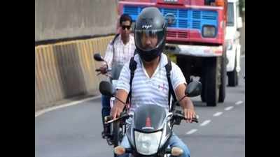 Traffic police give helmets to bikers caught for violations