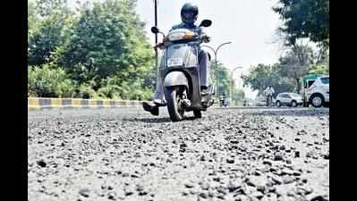 Shoddy patchwork, loose gravel make riding on Amravati Road a daunting task