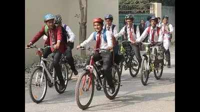 Faridabad schoolkids wear helmets while riding bi-cycles to create road safety awareness