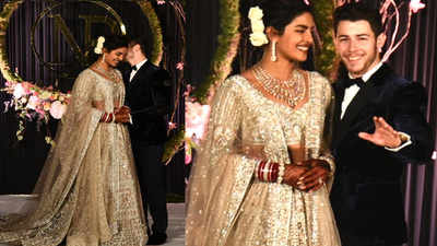 Priyanka Chopra and Nick Jonas pose for cameras at their wedding reception in Delhi