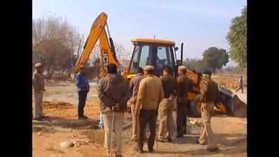 Gurugram MLA stands before excavator, stalls demolition of illegal houses