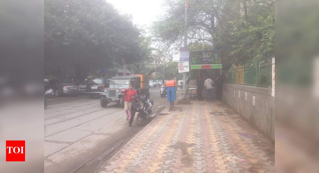 Footpath encroached on - Times of India