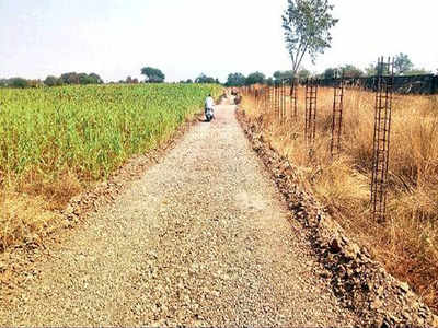 Farmers from 2 villages pool in land, build unpaved road