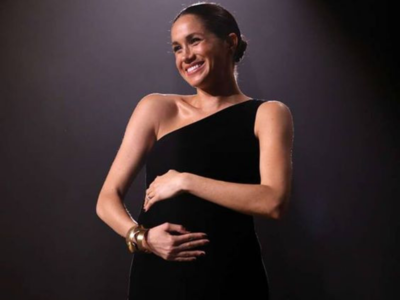 WATCH: Meghan Markle caressing her pregnant tummy as the royal baby kicks in is pure BLISS!