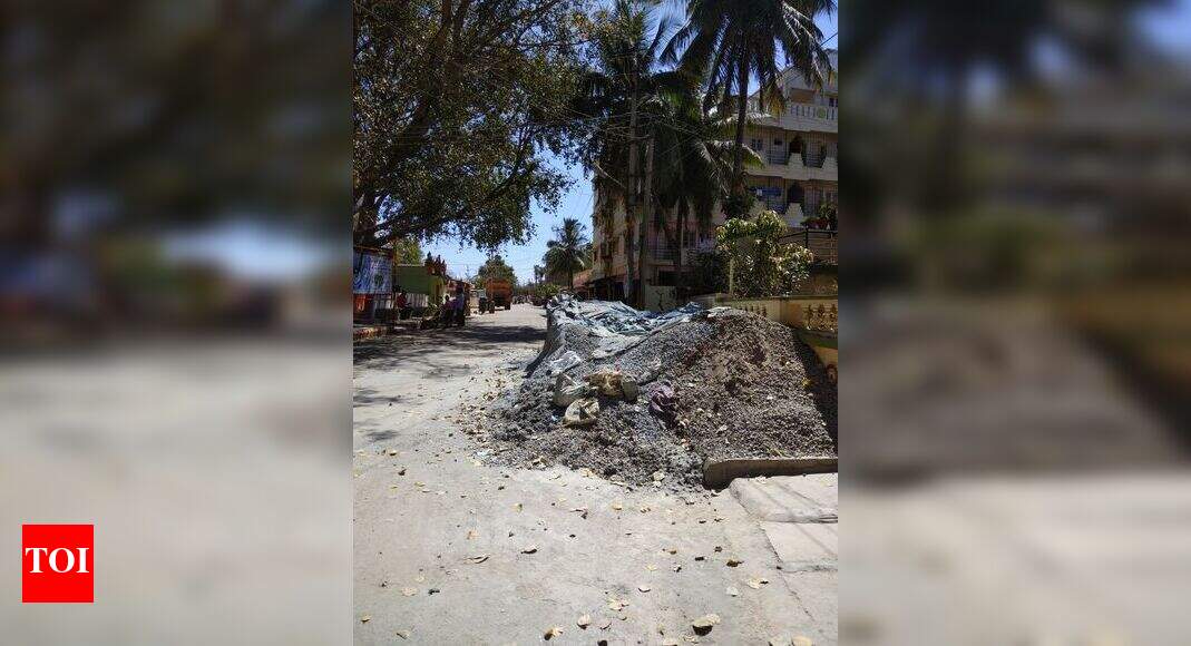 Footpath being encroached by private builder - Times of India