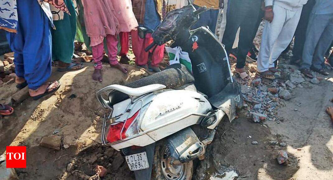 Woman falls off scooter, crushed by truck Noida News Times of India