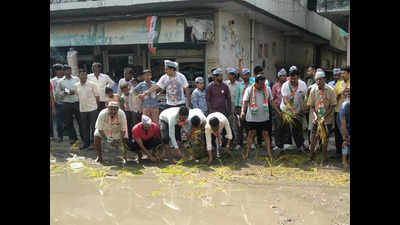 Locals plant paddy saplings on slushy road as sign of protest