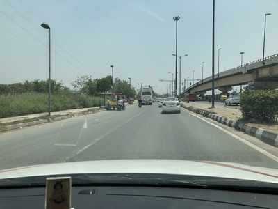 Vendor sits on side of busy road - Times of India