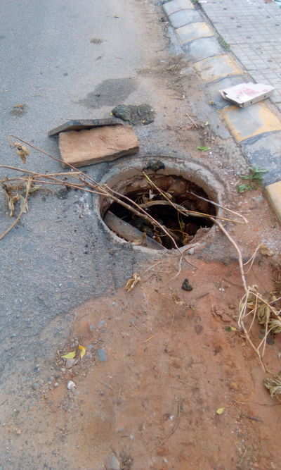 Manhole cover falls inside.