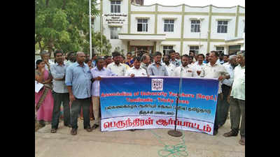 University teachers protest slow conversion of colleges