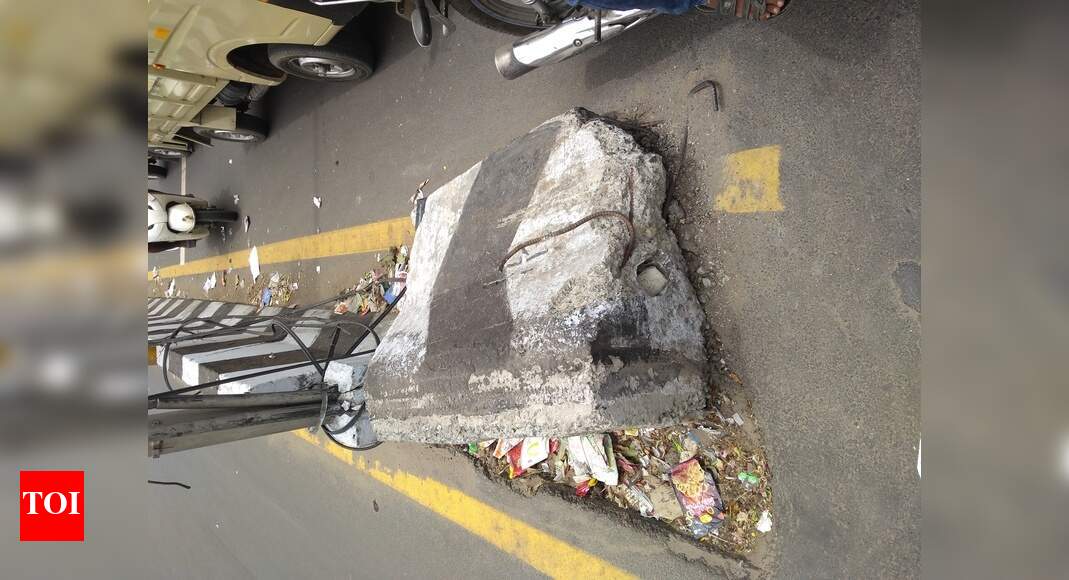 Broken concrete road divider - Times of India