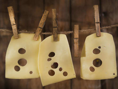 Why do some types of cheese have holes