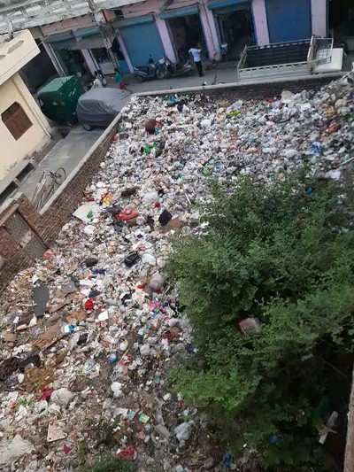 Garbage dump in empty plot in residential area.
