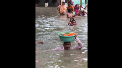 Vadodara cop carries baby girl in tub on his head in neck-deep water
