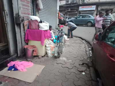 People residing on footpath, no place to walk