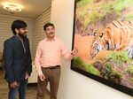 Wildlife photography enthusiasts​ attend a Tiger photo exhibition
