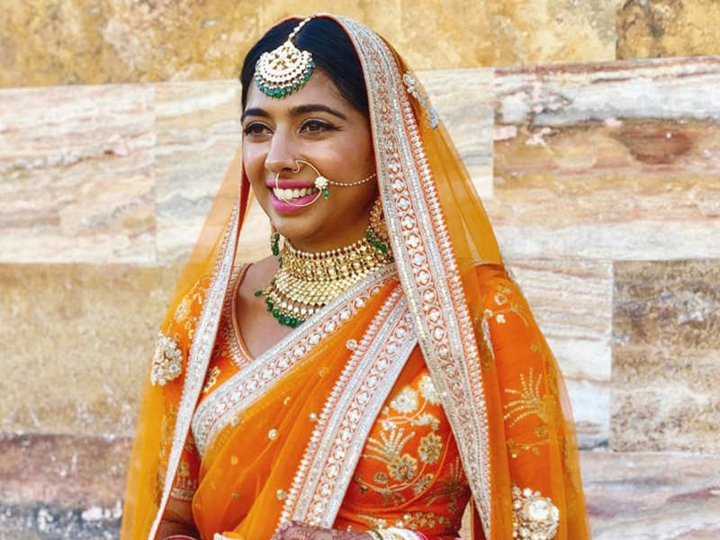 This bride wore a stunning orange lehenga for her day wedding in Mexico!
