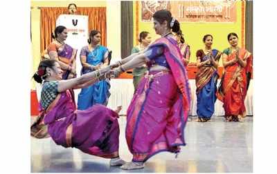 City women play traditional games dressed in nauvari saris