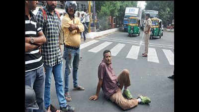 Son penalized, man lies down on road to protest