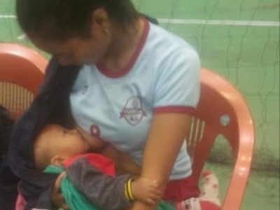 Mizoram volleyball player stops to feed her baby between the game