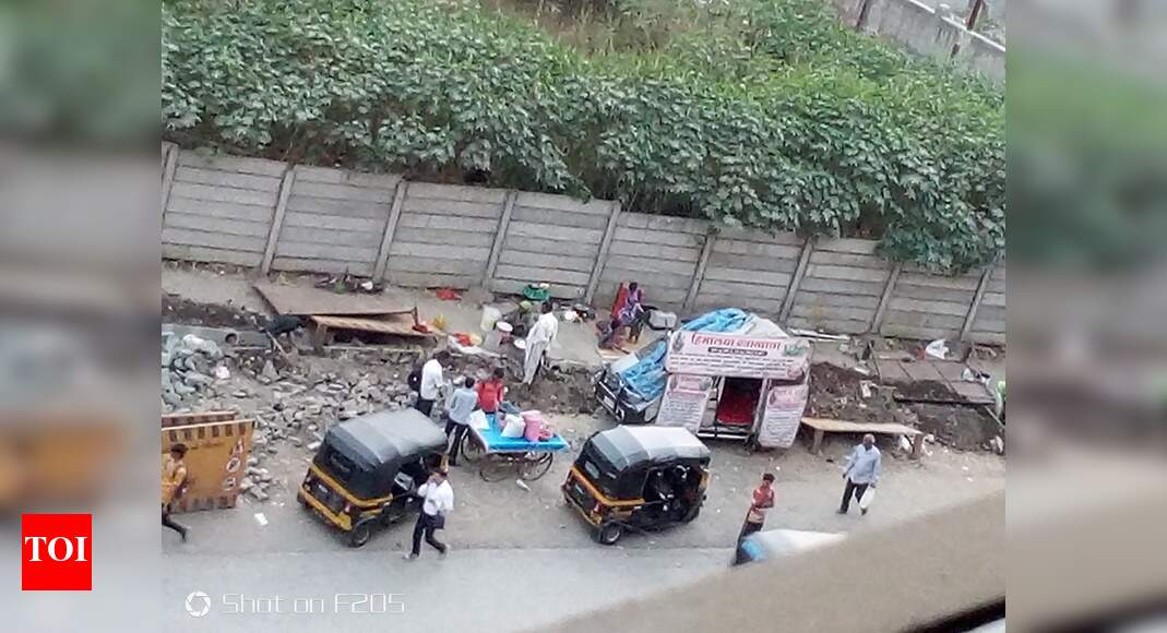 Footpath encroached - Times of India